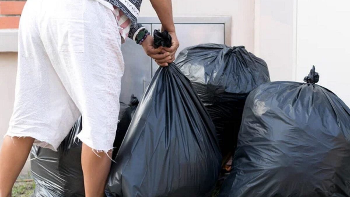 depositphotos_107454546-stock-photo-woman-taking-out-garbage-in (1)